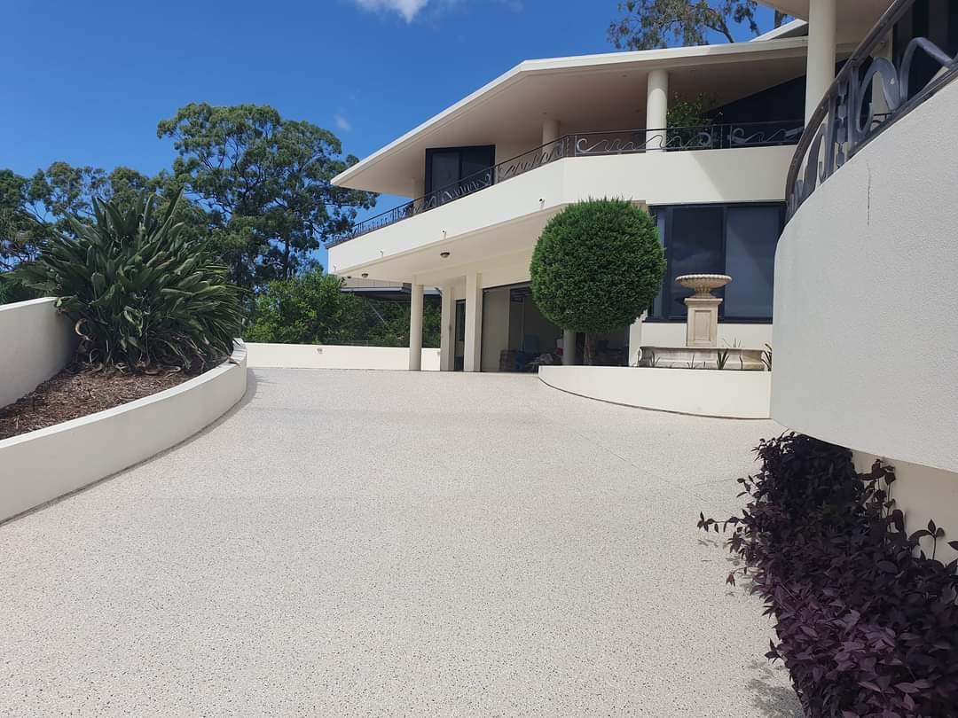 Cream flake coating across a wide residential driveway in Los Angeles