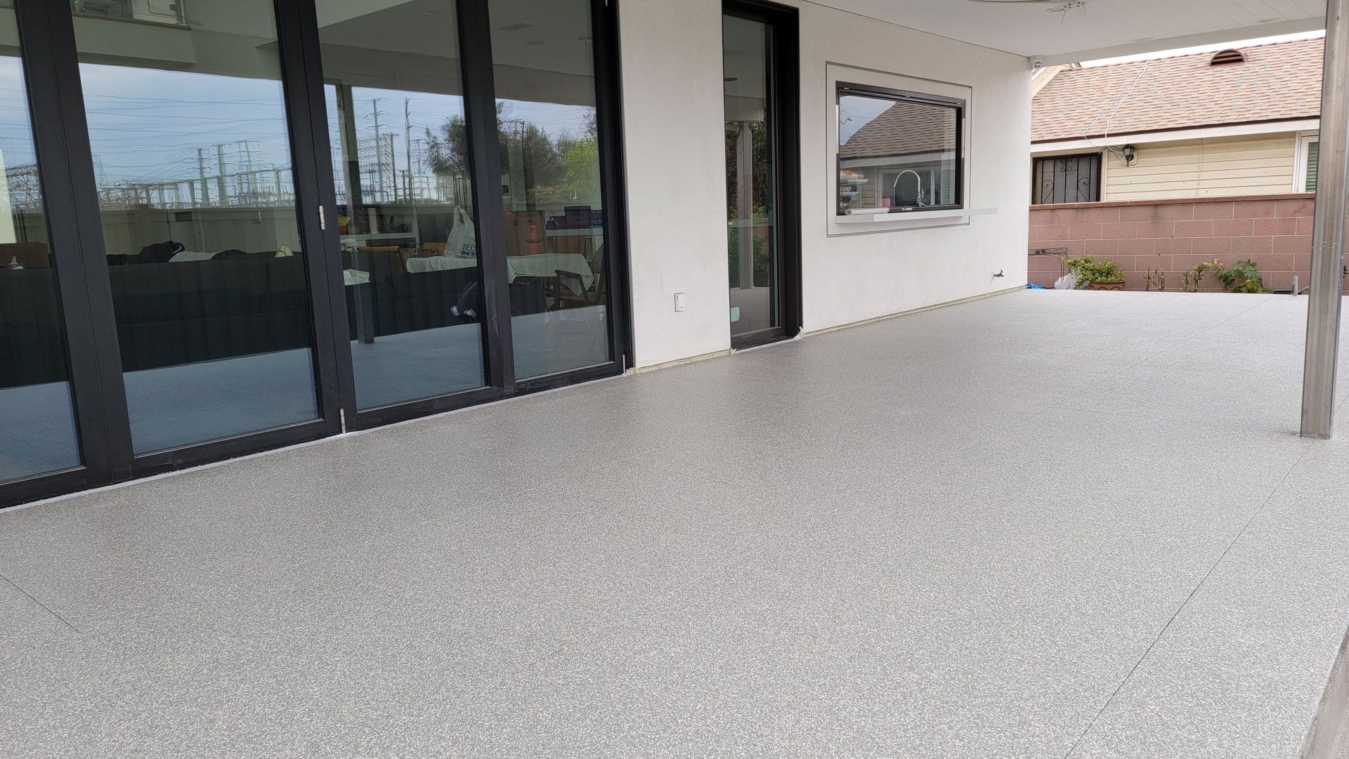 Covered patio with a gray flake concrete coating in Los Angeles