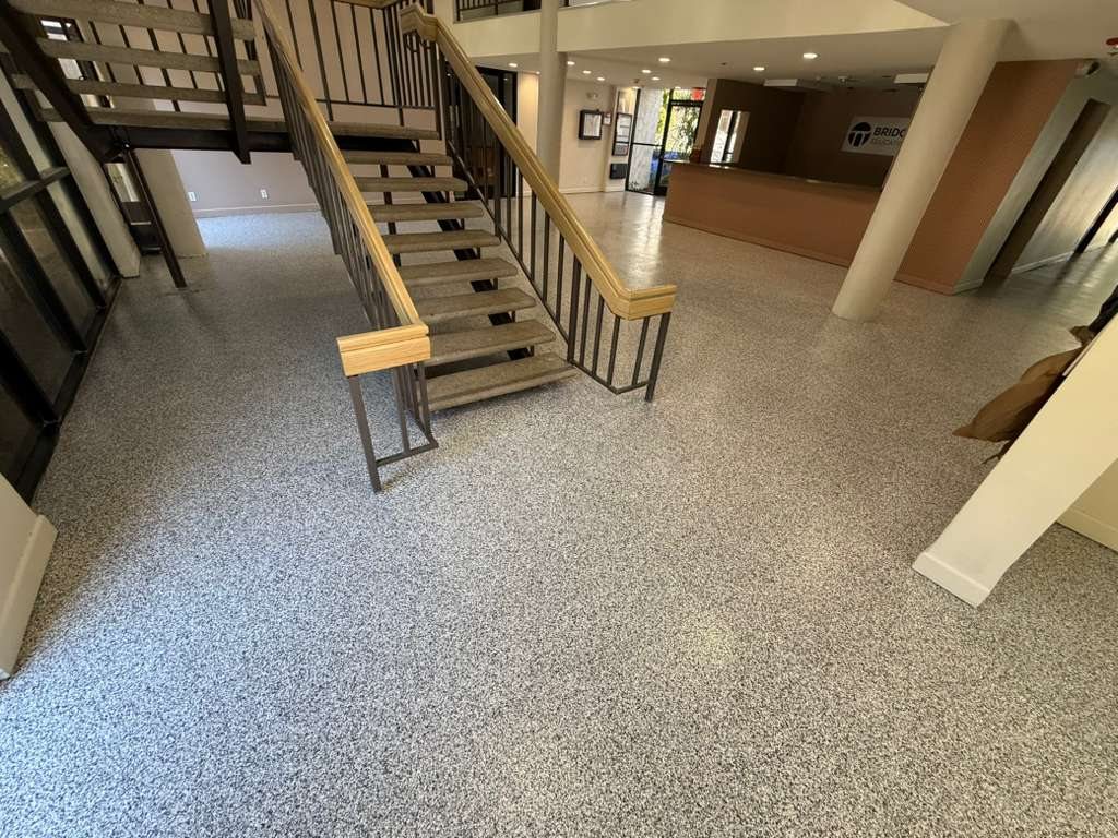 Flake system floor across a commercial lobby and stairs in Los Angeles