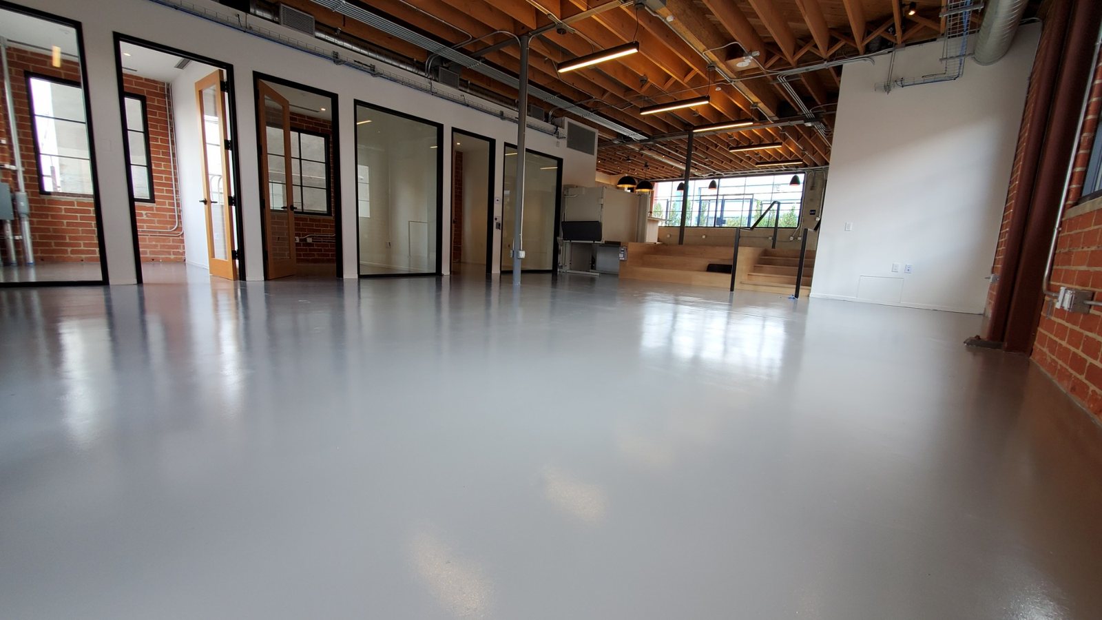 Gray epoxy floor across a creative loft office in Los Angeles