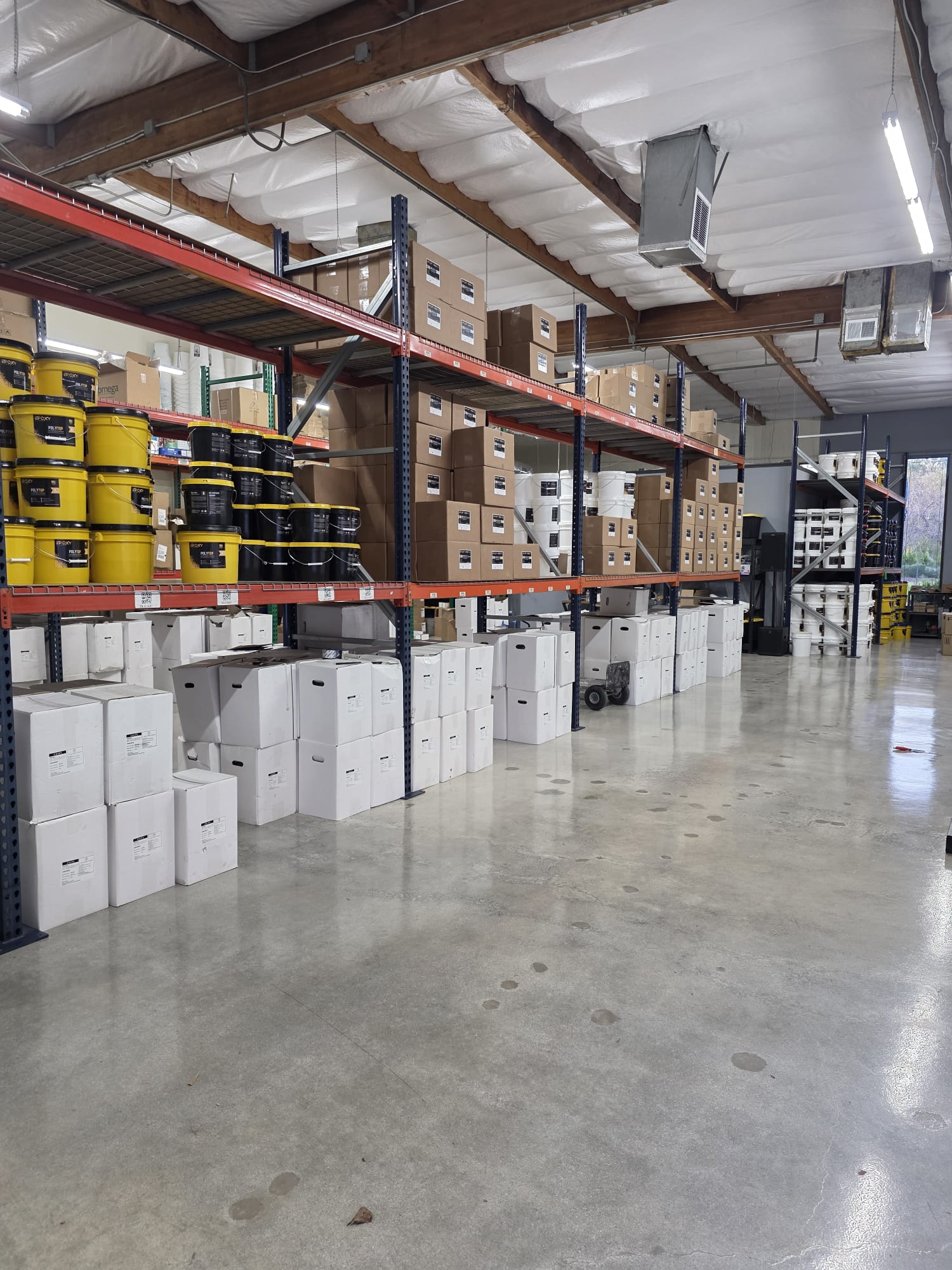 Top Epoxy Floors warehouse racking stocked with our own coating materials